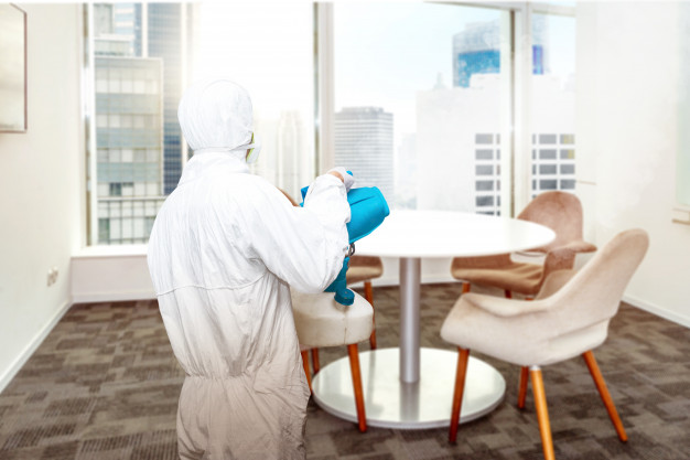 man white protective suit spraying disinfectant office room 9083 4318